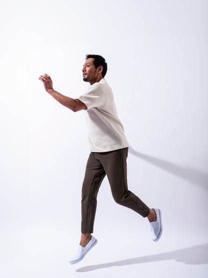 Man in white room leaping in Andy Joggers