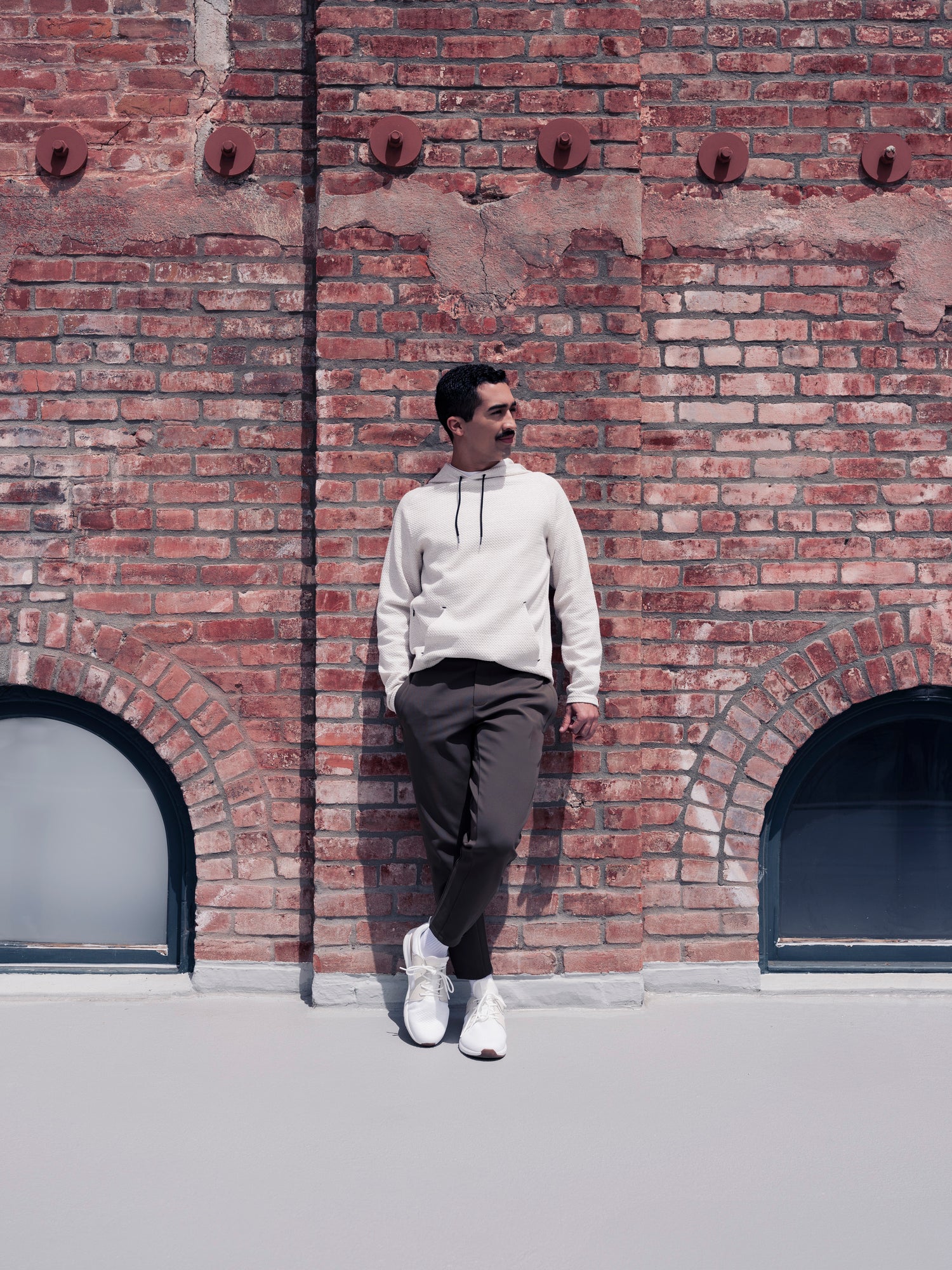 Man standing outside against brick wall wearing the Andy Joggers